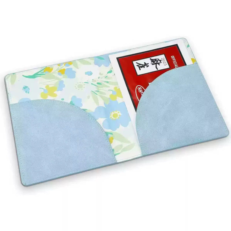 A light blue faux-leather card holder wallet with a floral patterned interior pocket and a red card partially inserted, shown on a white background.