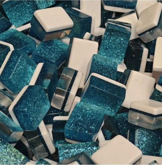 Blue glitter-backed American mahjong tiles with white faces