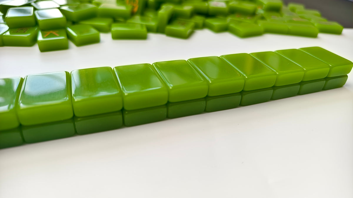 Green Spa Day American Mahjong tiles arranged in a row with glossy avocado-green tile backs.
