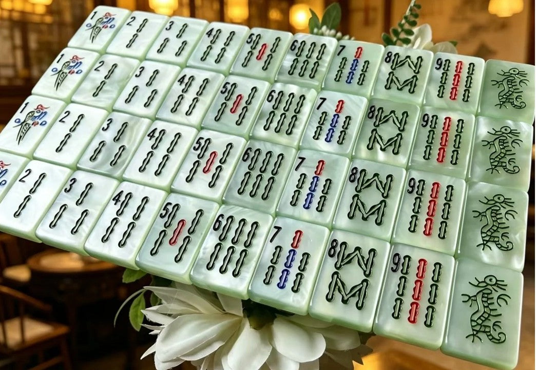 Classic Jade Mist American Mahjong tiles with pale green pearlescent finish and traditional black, red, blue and green markings.