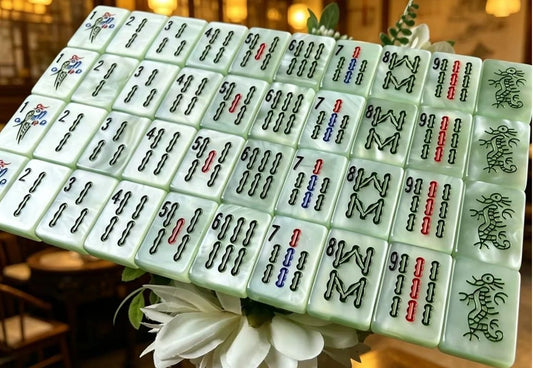 Classic Jade Mist American Mahjong tiles with pale green pearlescent finish and traditional black, red, blue and green markings.