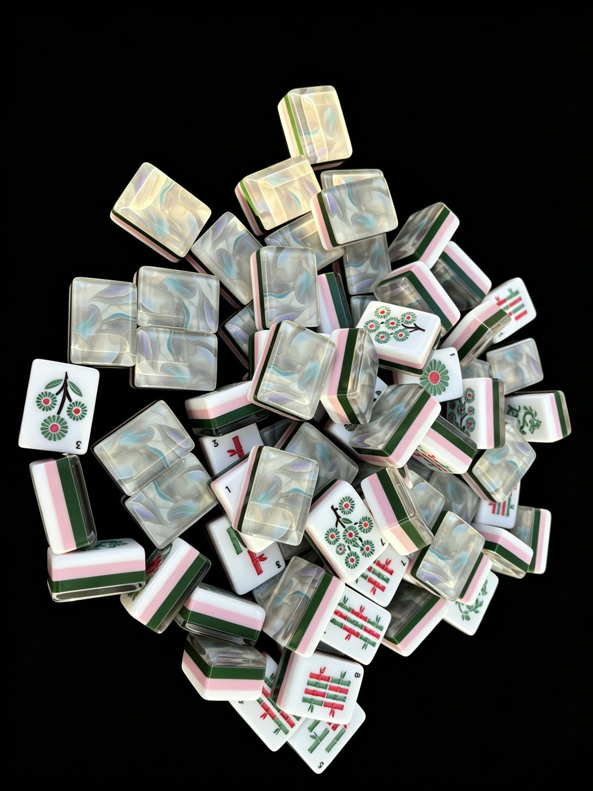 Opal Dream American Mahjong tiles with iridescent mother-of-pearl backs and pink, green and white layered edges.