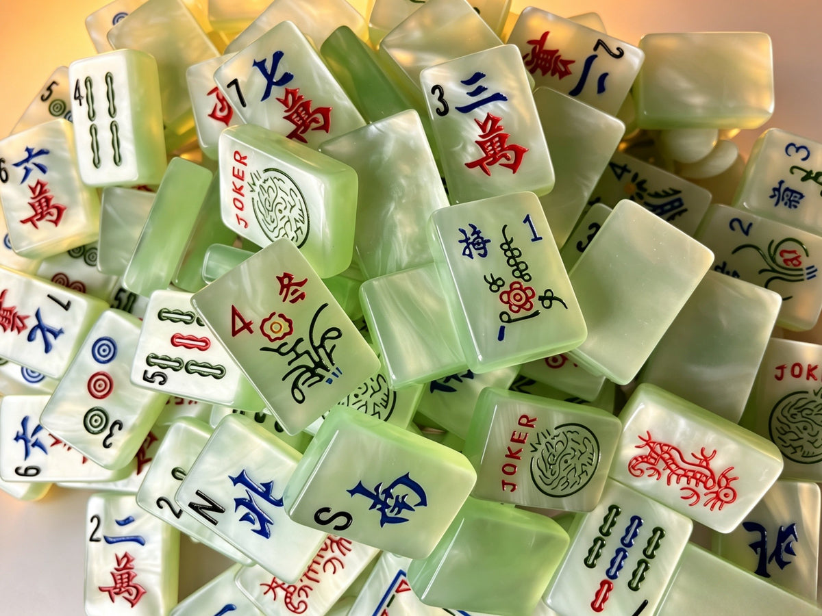 Classic Jade Mist American Mahjong tiles with pale green pearlescent finish and traditional black, red, blue and green markings.