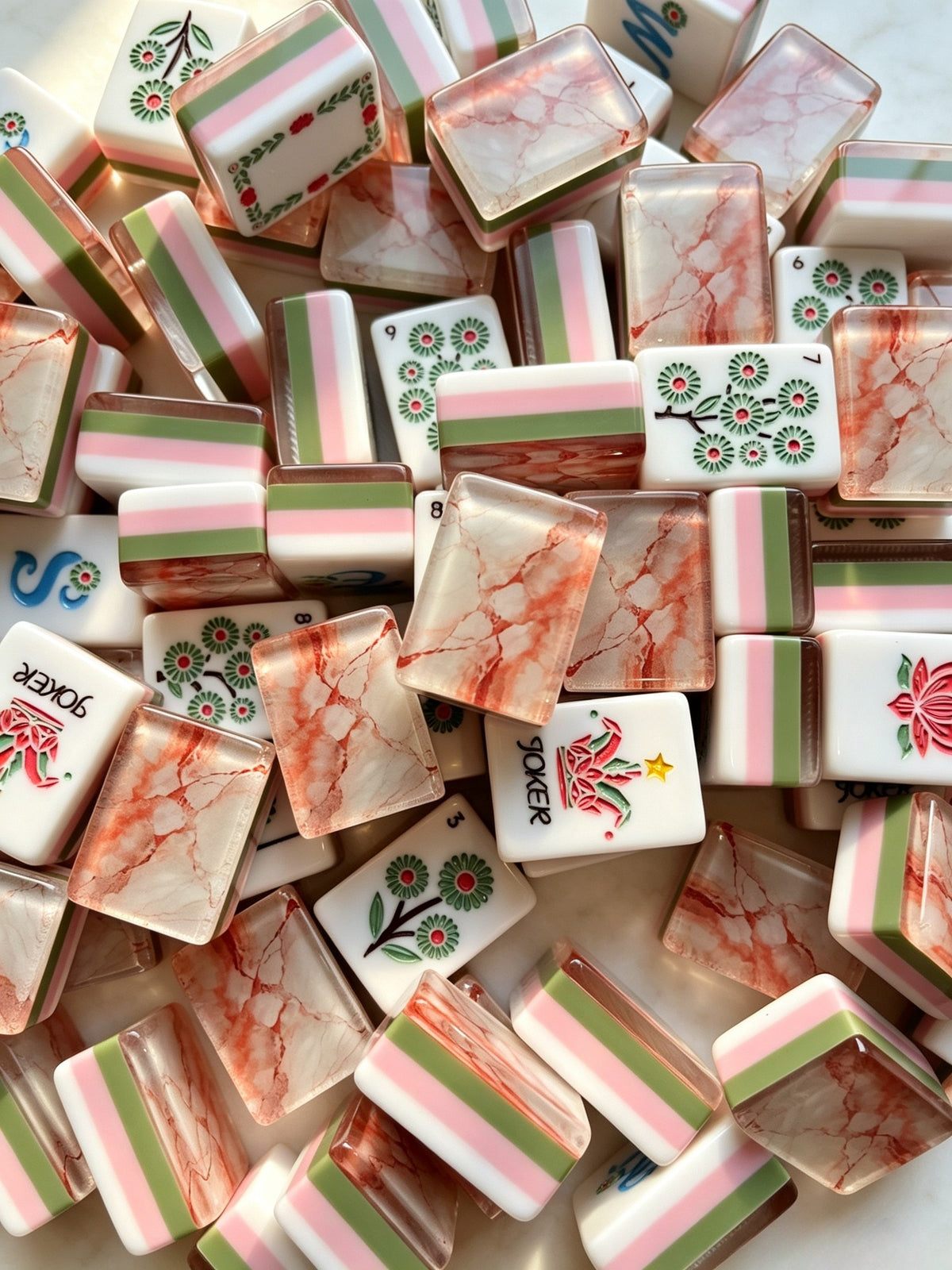 Blushing Garden American Mahjong Tile Set with floral Dots, bamboo Bams, vine-accented Craks, blue Winds, floral Jokers and blush marble tile backs.