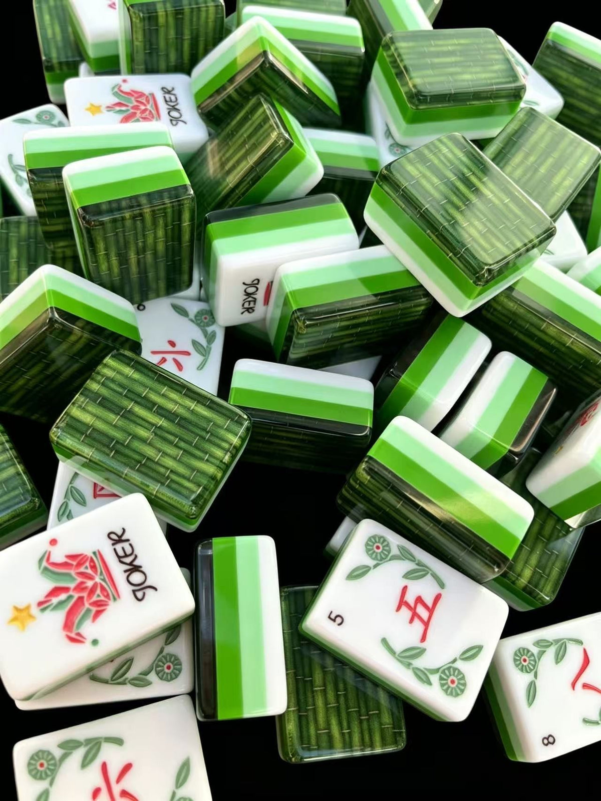Bamboo Garden American Mahjong tiles with woven bamboo-patterned backs, layered green and white edges, floral Craks and illustrated Jokers.