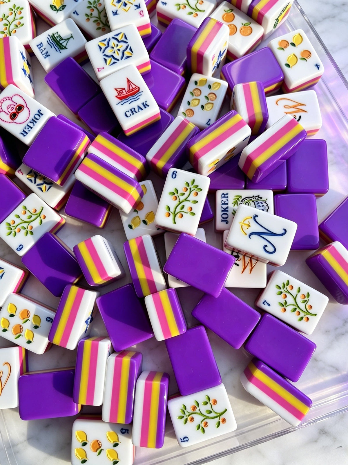 glossy purple backs, pink and yellow stripes, citrus Bams, Dots, Winds and Jokers.