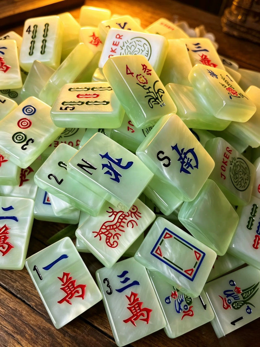 Classic Jade Mist American Mahjong tiles with pale green pearlescent finish and traditional black, red, blue and green markings.