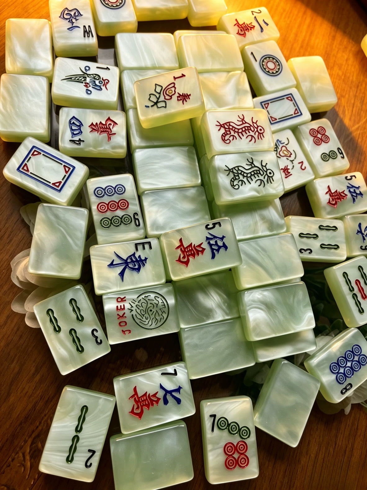 Classic Jade Mist American Mahjong tiles with pale green pearlescent finish and traditional black, red, blue and green markings.