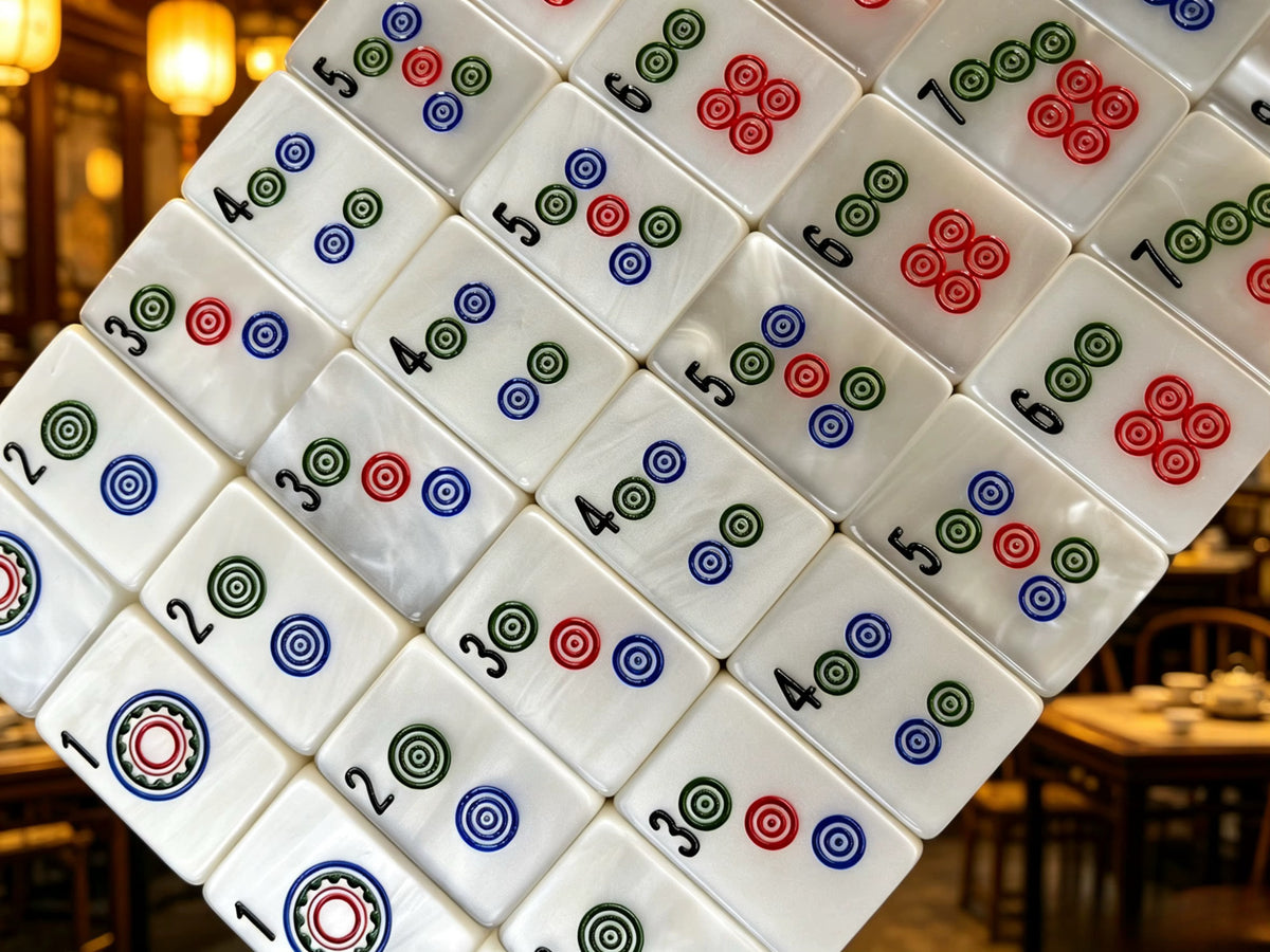 Classic Pearl American Mahjong tiles with luminous ivory mother-of-pearl finish and traditional red, green, blue and black markings.