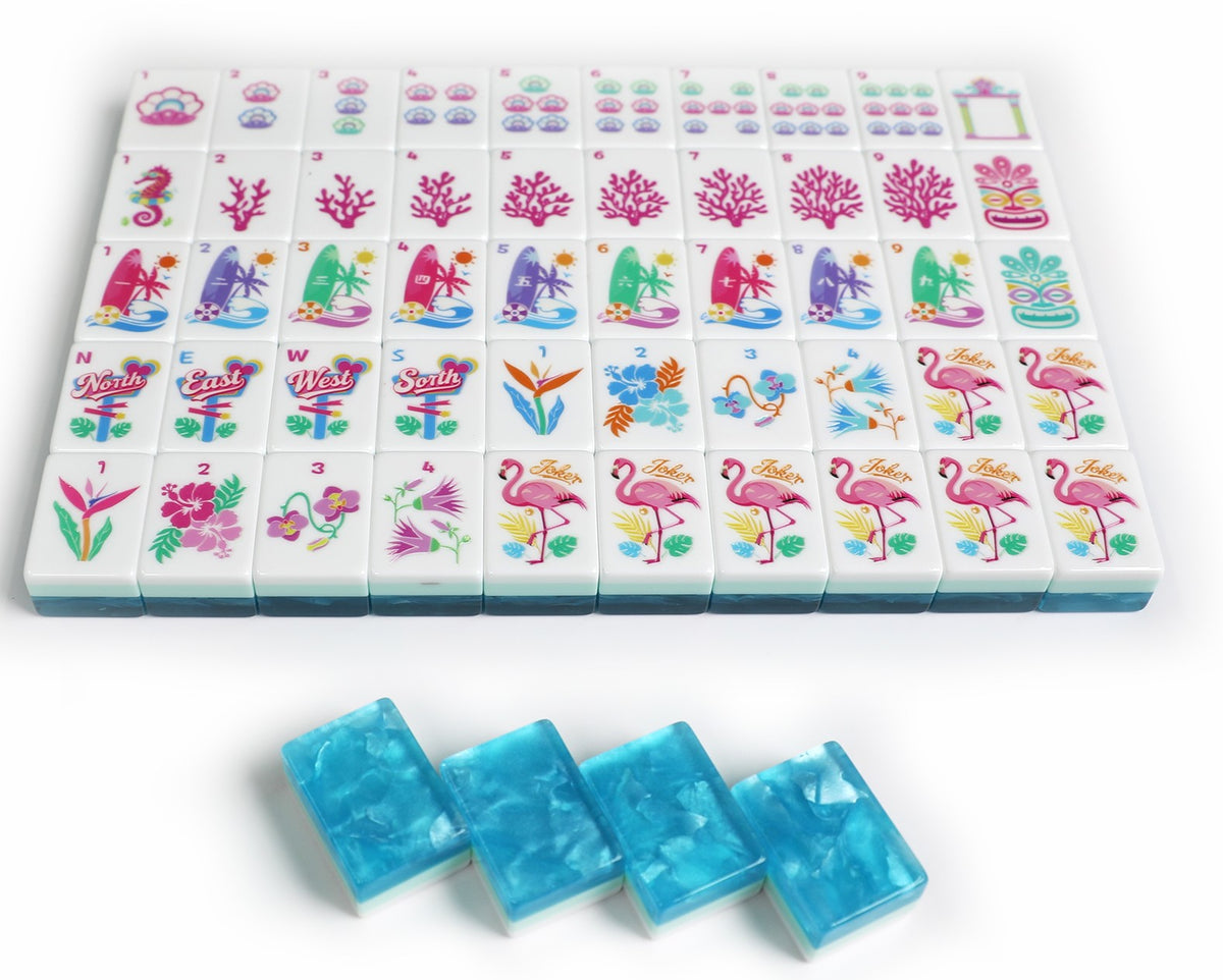 Mahjong set with a grid of white tiles decorated with colorful tropical and floral illustrations, plus four translucent blue rectangular pieces placed in front on a white background.