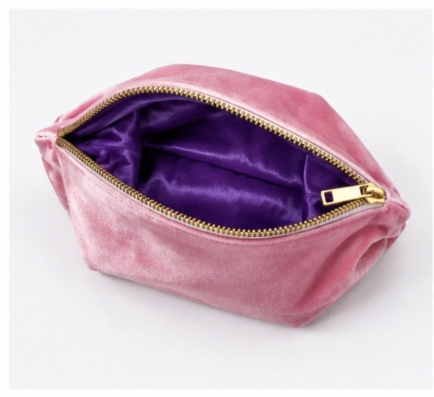 Pink velvet mahjong tile storage bag with purple satin lining and zipper closure