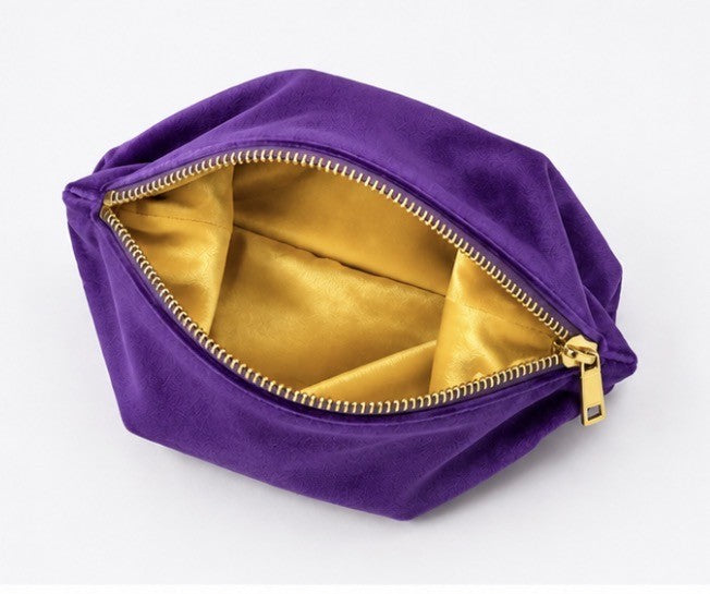 Purple velvet mahjong tile storage bag with yellow satin lining and zipper closure