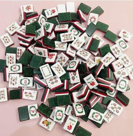Christmas American Mahjong tiles with festive artwork, red acrylic layers and sparkling green glitter backs