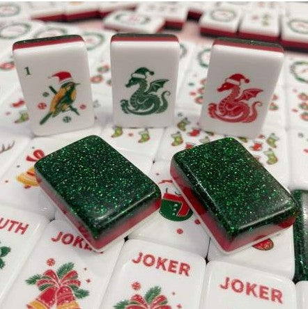 Christmas American Mahjong tiles featuring red and green dragons, holiday Jokers and sparkling green glitter backs